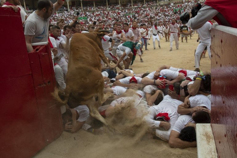 PAMPLONA, SPAIN - JULY 07: A heifer jumps over revellers in the bullring during the second day of the San Fermin Running of the Bulls festival on July 07, 2019 in Pamplona, Spain. The annual Fiesta de San Fermin, made famous by the 1926 novel of US writer Ernest Hemmingway entitled 'The Sun Also Rises', involves the daily running of the bulls through the historic heart of Pamplona to the bull ring. (Photo by Pablo Blazquez Dominguez/Getty Images)