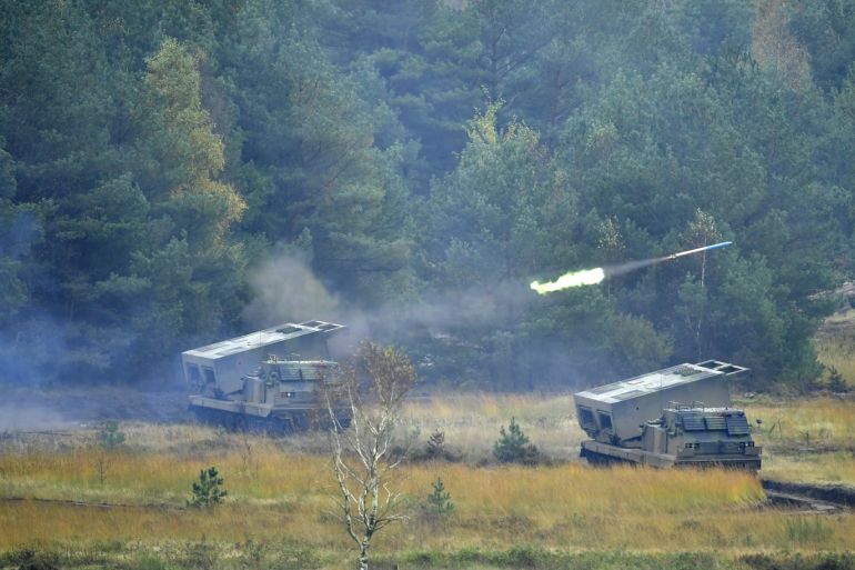 MUNSTER, GERMANY - OCTOBER 10: Two Mars rocket launcher tanks of the Bundeswehr, the German armed forces, during a simulated attack during military exercises on October 10, 20187 near Munster, Germany. Today's exercises, dubbed