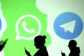 Silhouettes of mobile users are seen next to logos of social media apps Signal, Whatsapp and Telegram projected on a screen in this picture illustration taken March 28, 2018. REUTERS/Dado Ruvic/Illustration