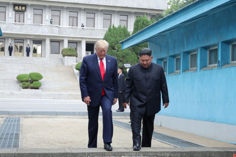 U.S. President Donald Trump and North Korean leader Kim Jong Un cross over a military demarcation line at the demilitarized zone (DMZ) separating the two Koreas, in Panmunjom, South Korea, June 30, 2019. KCNA via REUTERS ATTENTION EDITORS - THIS IMAGE WAS PROVIDED BY A THIRD PARTY. REUTERS IS UNABLE TO INDEPENDENTLY VERIFY THIS IMAGE. NO THIRD PARTY SALES. SOUTH KOREA OUT. NO COMMERCIAL OR EDITORIAL SALES IN SOUTH KOREA.