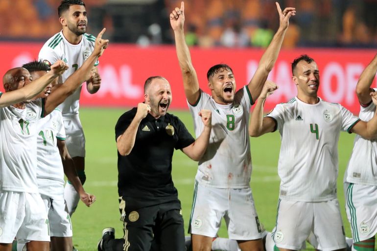 Soccer Football - Africa Cup of Nations 2019 - Final - Senegal v Algeria - Cairo International Stadium, Cairo, Egypt - July 19, 2019 Algeria's Riyad Mahrez, coach Djamel Belmadi and team mates celebrate in front of their fans after winning the Africa Cup of Nations REUTERS/Suhaib Salem