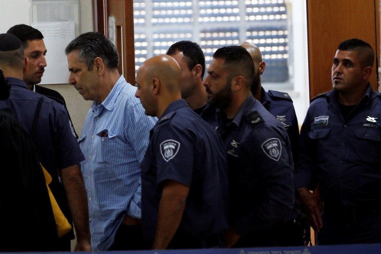 Gonen Segev, a former Israeli cabinet minister indicted on suspicion of spying for Iran, is escorted by prison guards as he leaves the court in Jerusalem, July 5, 2018 REUTERS/Ronen Zvulun