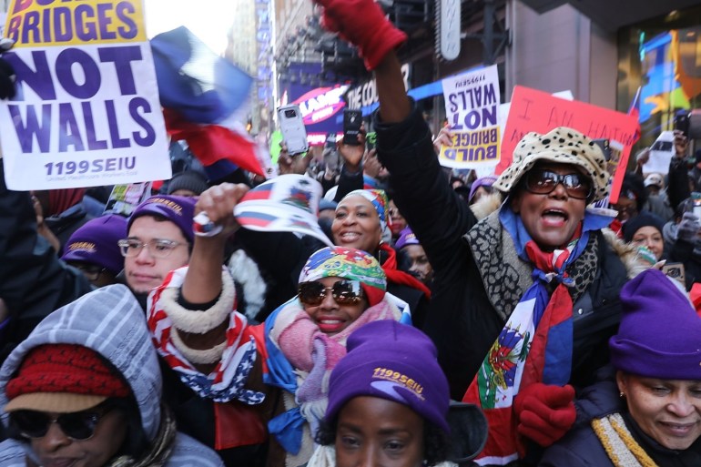NEW YORK, NY - JANUARY 15: Hundreds of people, many of them Haitian, demonstrate against racism in Times Square on Martin Luther King (MLK) Day on January 15, 2018 in New York City. Across the country activists, politicians and citizens alike are reacting to recent comments made by President Donald Trump that appeared to denigrate both Haiti and African nations during a meeting on immigration. Spencer Platt/Getty Images/AFP== FOR NEWSPAPERS, INTERNET, TELCOS & TELEVISION USE ONLY ==