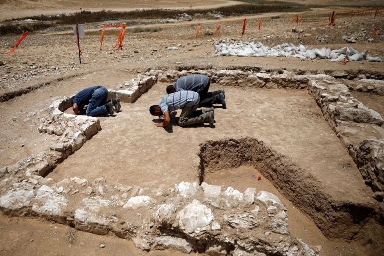 Workers pray inside the remains of a mosque discovered by the Israel Antiquities Authority and which they say is one of the world's oldest mosques, in the outskirts of the Bedouin town of Rahat in southern Israel July 18, 2019. REUTERS/Amir Cohen