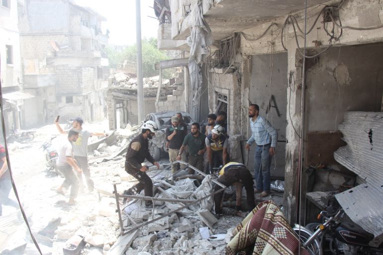 Airstrike in Syria's Idlib- - IDLIB, SYRIA - JULY 11: Civil defense team and locals carry out search and rescue works at the site around the collapsed buildings after warplanes of Assad regime forces and Russian forces hit the de-escalation zone, Jisr al-Shughur district of Idlib, Syria on July 11, 2019. It is reported that dead and wounded after the attack.
