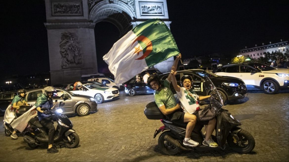epa07728282 Algeria supporters celebrate on the Champs-Elysees, near the Arc de Triomphe, after Algeria won the 2019 Africa Cup of Nations (AFCON2019) final soccer match against Senegal, in Paris, France, 19 July 2019. The 2019 Africa Cup of Nations (AFCON2019) was taking place from 21 June until 19 July 2019 in Egypt. EPA-EFE/IAN LANGSDON