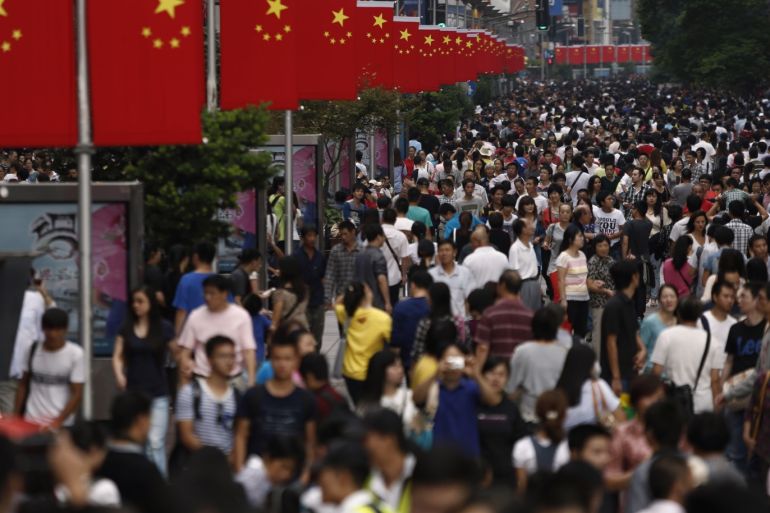 People walk along Nanjing road during the first day of China's National Day in Shanghai October 1, 2013. REUTERS/Aly Song (CHINA - Tags: SOCIETY)