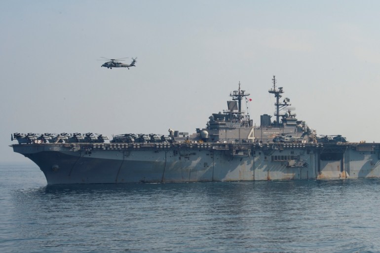 An SH-60 Sea Hawk flies over the U.S. Navy amphibious assault ship USS Boxer during a vertical replenishment-at-sea in the Arabian Gulf July 19, 2019. Picture taken July 19, 2019. U.S. Navy/Mass Communication Specialist 3rd Class Keypher Strombeck/Handout via REUTERS. ATTENTION EDITORS - THIS IMAGE HAS BEEN SUPPLIED BY A THIRD PARTY