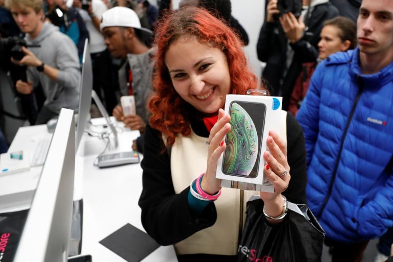 A customer reacts during the launch of the new iPhone XS and XS Max smartphones sales at