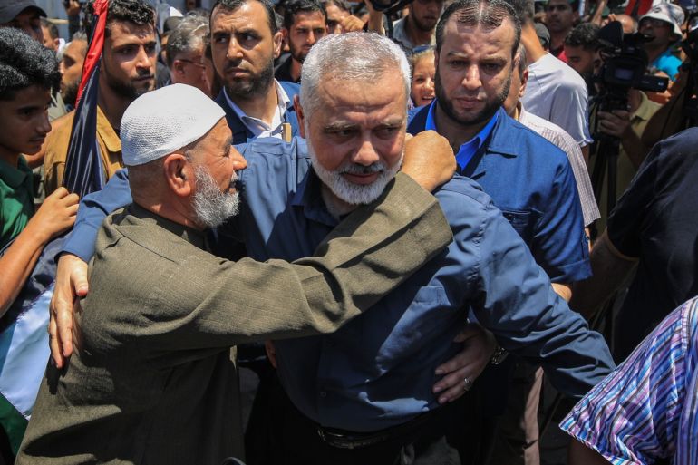 Protest against Bahrain workshop in Gaza- - GAZA CITY, GAZA - JUNE 26: Head of the Political Bureau of Hamas Ismail Haniyeh (C) is hugged by an eldery man during a demonstration against the U.S.-led conference in Bahrain, on June 26, 2019 in Gaza City, Gaza. A U.S.-led conference on its back-channel Middle East peace plan