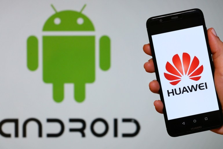 Huawei logo- - IZMIR, TURKEY - MAY 28: A person holds a Huawei mobile phone in front of logo of Android in Izmir, Turkey on May 28, 2019.
