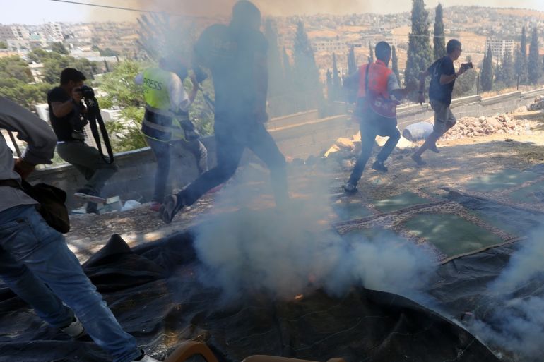 Reactions to Israel's demolition of houses in Jerusalem- - JERUSALEM - AUGUST 02 : Israeli forces launch tear gas as they intervene in a protest by Palestinians against the demolition of some of Palestinian houses by Israel in Sur Baher town on the southeastern outskirts of East Jerusalem on August 02, 2019.