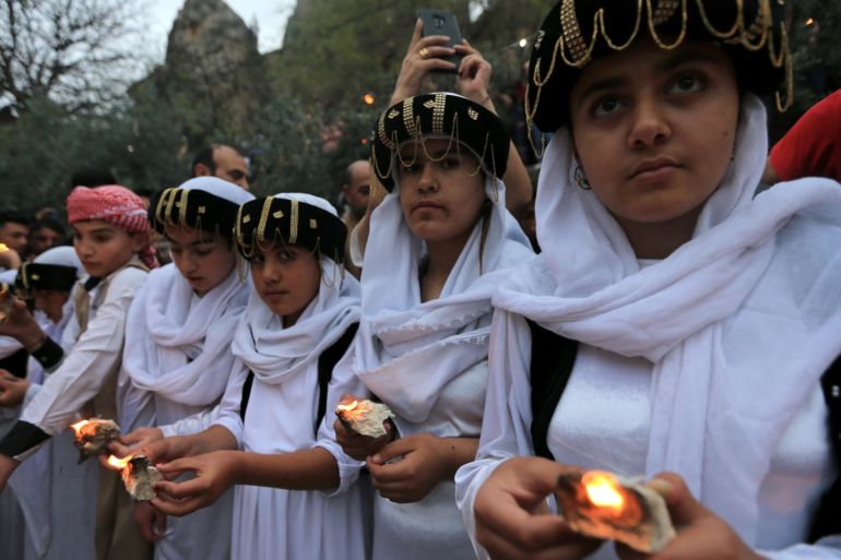 Iraqi Yazidis light candles and paraffin torches during a ceremony to celebrate the Yazidi New Year at Lalish temple in Shekhan District in Duhok province, Iraq April 16, 2019. REUTERS/Ari Jalal