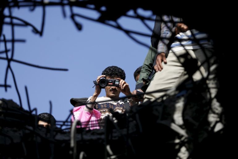 A journalist films the site of a Saudi-led air strike on a bridge in Yemen's capital Sanaa March 23, 2016. REUTERS/Khaled Abdullah