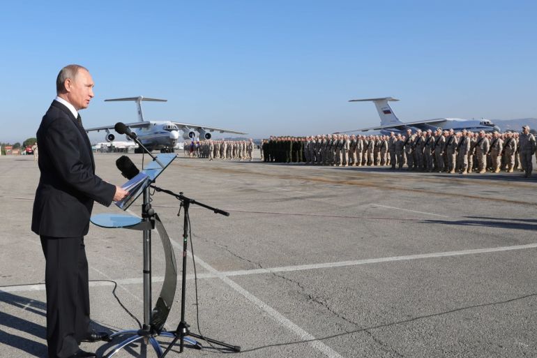 epa06584660 (FILE) - Russian President Vladimir Putin (L) visits the Hmeimim (also Khmeimim) Air Base, south-east of the city of Latakia in Syria, with transport planes seen on background 11 December 2017 (re-issued 06 March 2018). Reports 06 March 2018 state Russian Defense Ministry has confirmed a Russian military transport plane has crashed at the Khmeimim Air Base, killing 26 passengers and six members of the crew. EPA-EFE/MICHAEL KLIMENTYEV / SPUTNIK / KREMLIN / POOL MANDATORY CREDIT
