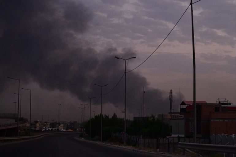epa07770478 A view of the explosion of a weapon stash belonging to the Sayid al-Shuhadaa combat division part of al-Hashd al-Shaabi (Popular Mobilization Forces), near Baghdad, Iraq, on 12 August 2019. According to Iraq's interior ministry the cause of the explosion has not yet been determined and 13 people were injured. EPA-EFE/MURTAJA LATEEF