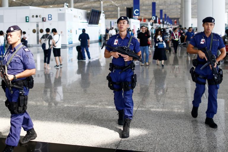 Armed police patrol the departure hall of the airport in Hong Kong after previous night's clashes with protesters, China August 14, 2019. REUTERS/Thomas Peter