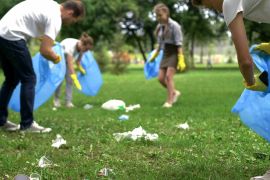 Friendly family organized cleaning day to clean park of household garbage