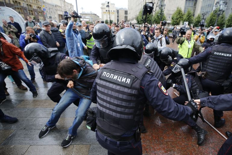 Unsanctioned rally in Moscow- - MOSCOW, RUSSIA - AUGUST 03: Riot police officers detain a participant of an unsanctioned rally urging fair elections at Pushkinskaya Square in Moscow, Russia on August 03, 2019. The rally is the latest in a series of demonstrations after officials refused to let popular opposition candidates run in next month's city parliament elections.