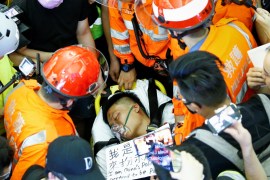 Medics attempt to remove an injured man, who some anti-government protesters said was an undercover police officer from mainland China, at the airport in Hong Kong, China August 13, 2019. Picture taken August 13, 2019. REUTERS/Thomas Peter