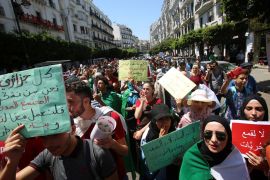 Students hold placards during an anti-government demonstration in Algiers, Algeria July 16, 2019. The Arabic writing on one of the placards (R) reads: " No to suppressing freedom " REUTERS/Ramzi Boudina