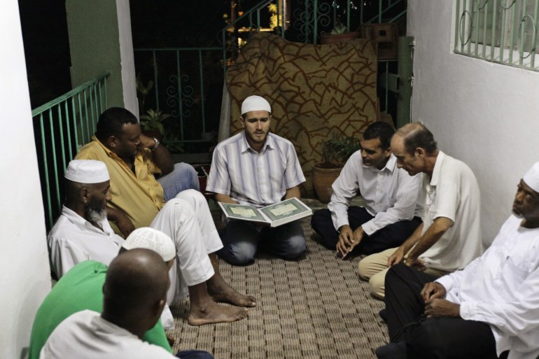 Cuban Muslims listen to verses from the Koran after their Iftar (fast-breaking) meal during the Islamic holy month of Ramadan in Havana August 3, 2012. As Muslims around the world participate in the month-long fast of Ramadan, a small population of Cuban faithful are facing challenges for one of the newer religions to come to the island. Cuba, a country known for its strong Catholic, Communist and Caribbean identity, is home to around 7,800 Muslims, according to the isl