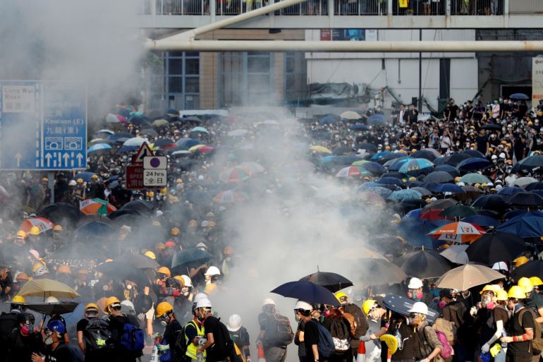 Protesters react after tear gas was fired by the police during a demonstration in support of the city-wide strike and to call for democratic reforms outside Central Government Complex in Hong Kong, China, August 5, 2019. REUTERS/Kim Kyung-Hoon