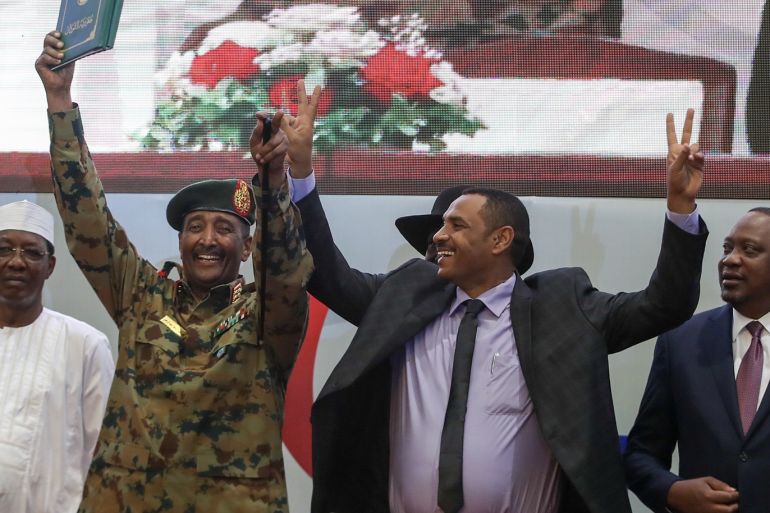 Signing ceremony of Constitutional Declaration in Sudan- - KHARTOUM, SUDAN - JULY 17 : Sudanese General and Vice President of Sudanese Transitional Military Council, Mohamed Hamdan Dagalo and Sudan's Forces of Freedom and Change coalition's leader Ahmad al-Rabiah greet after signing an agreement in Khartoum on July 17, 2019. Sudan's ruling military council and a coalition of opposition groups on Wednesday signed a political deal that paves the way for the handover of