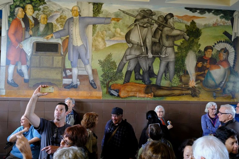People fill the main entryway of George Washington High School to view the controversial 13-panel, 1,600-square foot mural, the "Life of Washington," in San Francisco. (Eric Risberg)