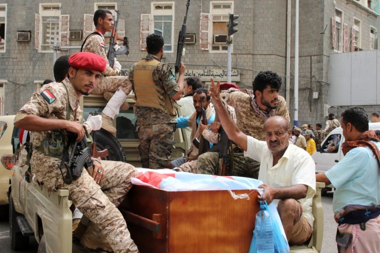 Yemen's southern separatists sit in the back of a vehicle with a coffin of one comrades of Brigadier General Muneer al-Yafee killed in a Houthi missile attack, during their funeral in Aden, Yemen, August 7, 2019. REUTERS/Fawaz Salman