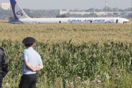 epa07774163 Russian police officers near the site of Ural Airlines A-321 passenger plane emergency landing outside Zhukovsky airport in Ramensky district of Moscow region, Russia, 15 August 2019. A-321 with 226 passengers and seven crew members on board en-route from Moscow to Simferopol made emergency landing after a right engine failure following the plane's colliding with seagulls shortly after take-off. Ten people were hospitalized following the accident. EPA-EFE/S