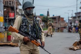 SRINAGAR, KASHMIR, INDIA - AUGUST 17: Indian government forces stand alert amid curfew like restrictions in the old city, after Indian authorities revoked Article 370 and Article 35A, on August 17, 2019 in Srinagar, the summer capital of Indian administered Kashmir, India. Curfew like restrictions remain in place in Kashmir for the thirteenth consecutive day after India revoked articles 370 and 35A, and phone and internet services also remained suspended. Article 35A of the Indian Constitution was an article that empowered the Jammu and Kashmir state's legislature to define permanent residents of the state and provided special rights and privileges to those permanent residents, also preventing non-locals from buying or owning property in the state. Prior to 1947, Jammu and Kashmir was a princely state under the British Empire. It was added to the Constitution through a Presidential Order. The Constitution Order 1954, (Application to Jammu and Kashmir) was issued by the President of India on 14 May, 1954 in accordance with Article 370 of the Indian Constitution, and with the concurrence of the Government of the State of Jammu and Kashmir. Kashmir has been a state under siege, with both India and Pakistan laying claim to it. Human rights organizations say more than 80,000 have died in the two decade long conflict with the Indian government claiming the number as 42,000. (Photo by Yawar Nazir/ Getty Images)