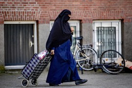 epa07749858 (FILE) - A nikab veiled woman pulls her shopping bag along a street in Rotterdam, Netherlands, 29 July 2019 (Issued on 31 July 2019). Facial coverings will be banned in the Netherlands, from public transport, schools, hospitals and government buildings as of 01 August 2019. The Dutch Islamic political party NIDA has announced a plan to pay for all fines received by wearers of the burka and niqab when the new law comes into effect next. EPA-EFE/ROBIN UTRECHT