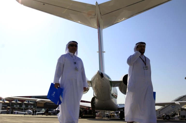 Visitors walk past aircraft on display during the Middle East Business Aviation show at Al Maktoum International Airport in Dubai World Central, December 11, 2012. REUTERS/Jumana El Heloueh (UNITED ARAB EMIRATES - Tags: TRANSPORT BUSINESS)
