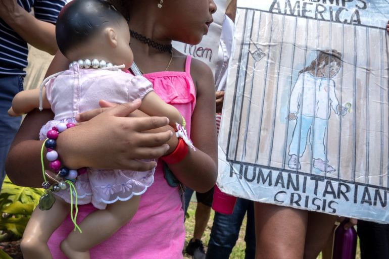 epa07690386 An unidentified girl carries a doll while she stands next to Immigration activists demanding the end of the migrant detention centers in the US, in front of Senator Marco Rubio's office building in Miami, Florida, USA, 02 July 2019. Over 170 demonstrations named #CloseTheCamps are taking place across the country, including cities like Miami, New York, Los Angeles and in border communities. EPA-EFE/CRISTOBAL HERRERA