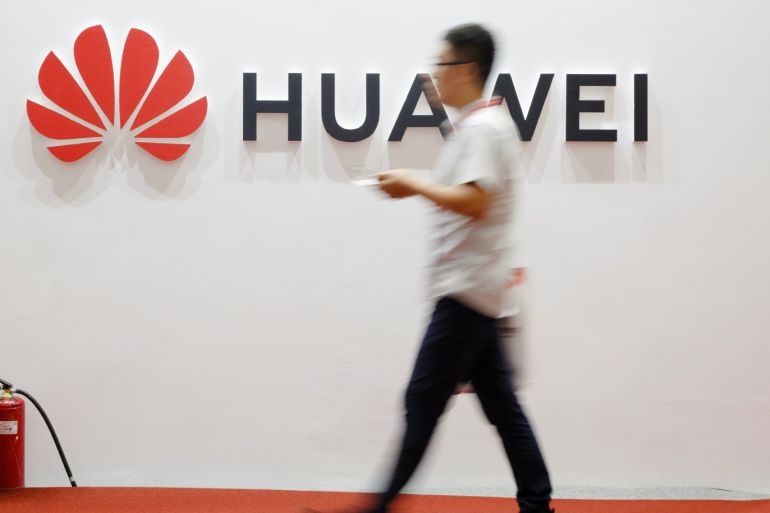A man walks past a Huawei company logo at the International Consumer Electronics Expo in Beijing, China August 2, 2019. REUTERS/Thomas Peter