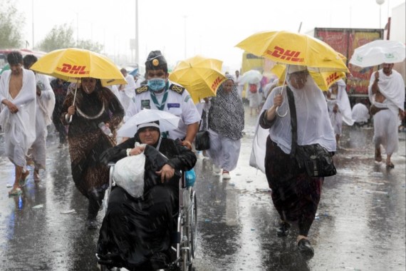 epa07766412 Muslim pilgrims hold umbrellas as rain falls during the Hajj pilgrimage near the Mount Arafat, close to Mecca, Saudi Arabia, 10 August 2019. According to Saudi authorities, around 2.5 million Muslims are expected to attend this year's Hajj pilgrimage, which is highlighted by the Day of Arafah, one day prior to Eid al-Adha. Eid al-Adha is the holiest of the two Muslims holidays celebrated each year, it marks the yearly Muslim pilgrimage (Hajj) to visit Mecca