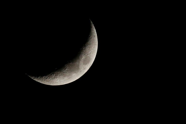 A crescent moon is seen in the sky of Amman, Jordan May 19, 2018. REUTERS/Muhammad Hamed