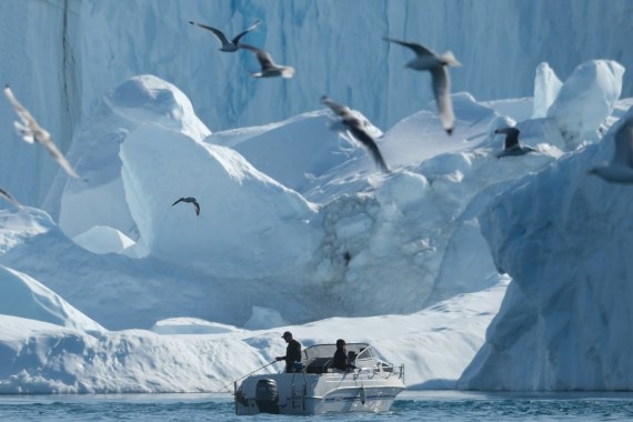 ILULISSAT, GREENLAND - AUGUST 04: A man fishes near icebergs in the Ilulissat Icefjord on August 04, 2019 in Ilulissat, Greenland. As the Earth's climate warms summers have become longer in Ilulissat, allowing fishermen a wider period to fish from boats on open waters and extending the summer tourist season. Long term benefits are uncertain, however, as warming waters could have a negative impact on the local fish and whale population. (Photo by Sean Gallup/Getty Images)