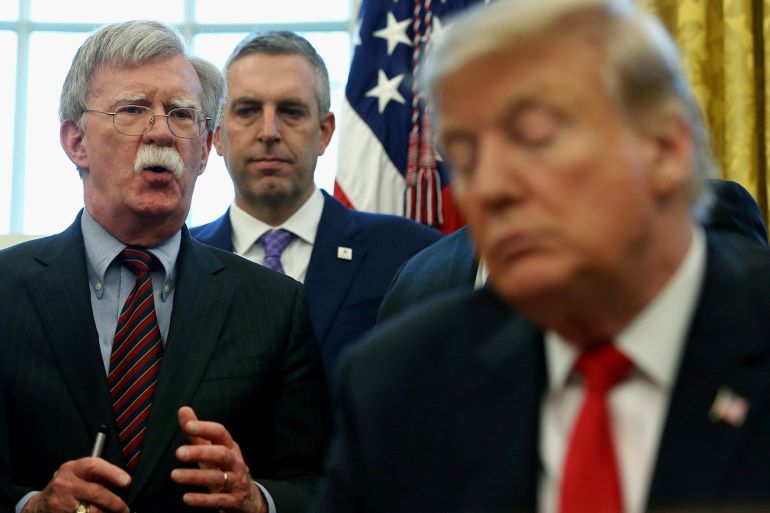 FILE PHOTO: U.S. President Donald Trump listens as his national security adviser John Bolton speaks during a presidential memorandum signing for the "Women's Global Development and Prosperity" initiative in the Oval Office at the White House in Washington, U.S., February 7, 2019. REUTERS/Leah Millis/File Photo