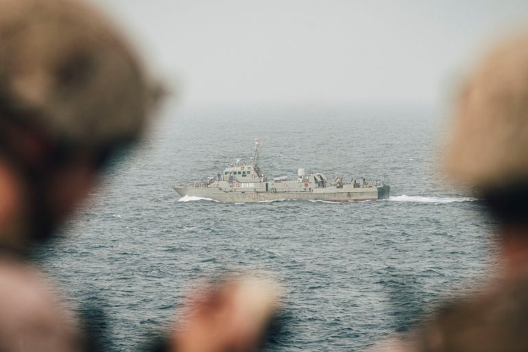 Marines onboard the amphibious transport dock ship USS John P. Murtha (LPD 26) observe an Iranian fast attack craft as it transits the Strait of Hormuz, off Oman, in this undated handout picture released by U.S. Navy on August 12, 2019. Donald Holbert/U.S. Navy/Handout via REUTERS ATTENTION EDITORS- THIS IMAGE HAS BEEN SUPPLIED BY A THIRD PARTY.