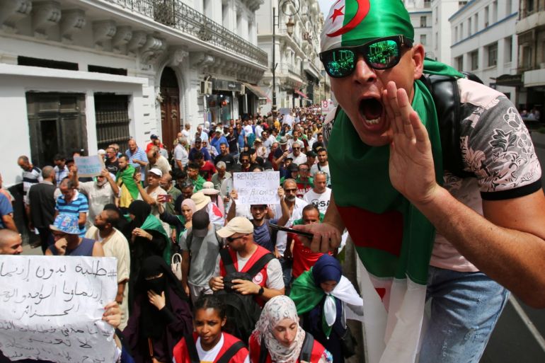 A demonstrator shouts slogans during a protest demanding social and economic reforms as well as the departure of the country's ruling elite in Algiers, Algeria August 27, 2019. REUTERS/Ramzi Boudina