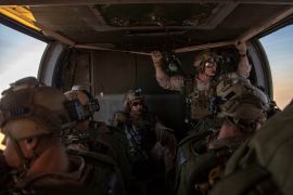 Marines assigned to Maritime Raid Force, 11th Marine Expeditionary Unit (MEU) prepare to jump out of a UH-60 Black Hawk at Camp Buehring, Kuwait City, Kuwait, in this undated handout picture released by U.S. Navy on August 4, 2019. Jared Sabins/U.S. Army/Handout via REUTERS ATTENTION EDITORS- THIS IMAGE HAS BEEN SUPPLIED BY A THIRD PARTY.
