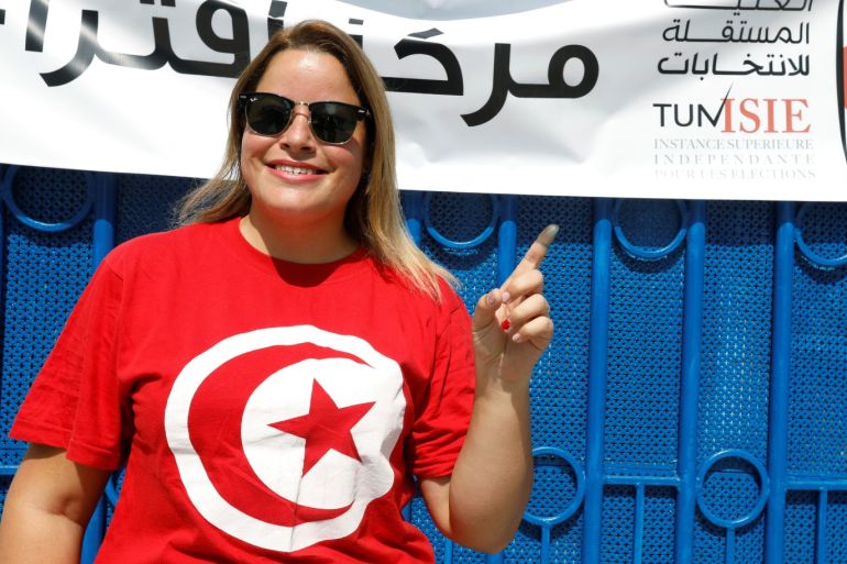 A woman poses after casting her vote outside a polling station during presidential election in Tunis, Tunisia, September 15, 2019. REUTERS/Zoubeir Souissi