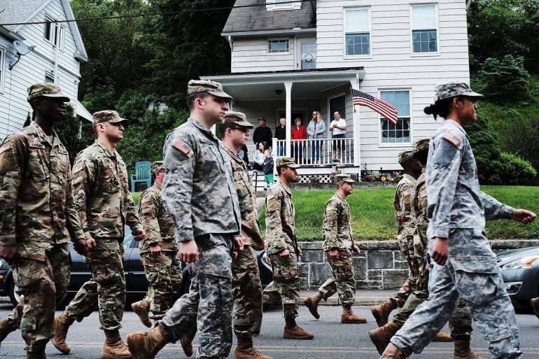 NAUGATUCK, CT - MAY 28: People watch as soldiers march through the streets of Naugatuck in the annual Memorial Day Parade on May 28, 2018 in Naugatuck, Connecticut. Across America, towns and cities will be remembering those who lost their lives while serving in the United States Armed Forces. Memorial Day is a federal holiday in America and has been celebrated since the end of the Civil War. Spencer Platt/Getty Images/AFP== FOR NEWSPAPERS, INTERNET, TELCOS & TELEVISION USE ONLY ==