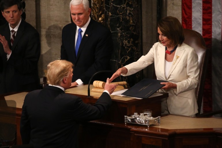 Speaker of the House Nancy Pelosi (D-CA) shakes hands with U.S. President Donald Trump in front of Vice President Mike Pence as the president arrives to deliver his second State of the Union address to a joint session of the U.S. Congress in the House Chamber of the U.S. Capitol on Capitol Hill in Washington, U.S. February 5, 2019. REUTERS/Leah Millis