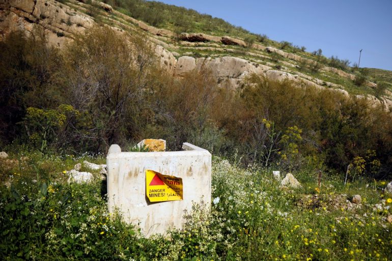 A sign warning of mines is seen in the Bedouin village of Al-Maleh in Jordan valley in the Israeli-occupied West Bank March 13, 2019. Picture taken March 13, 2019. REUTERS/Raneen Sawafta