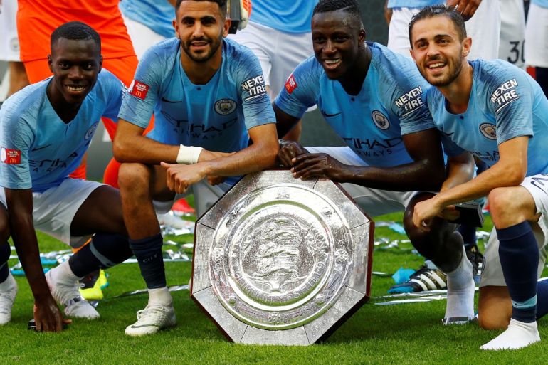 Soccer Football - FA Community Shield - Manchester City v Chelsea - Wembley Stadium, London, Britain - August 5, 2018 Manchester CityÕs Riyad Mahrez, Benjamin Mendy, Claudio Gomes and Bernardo Silva celebrate with the trophy after the match REUTERS/Phil Noble
