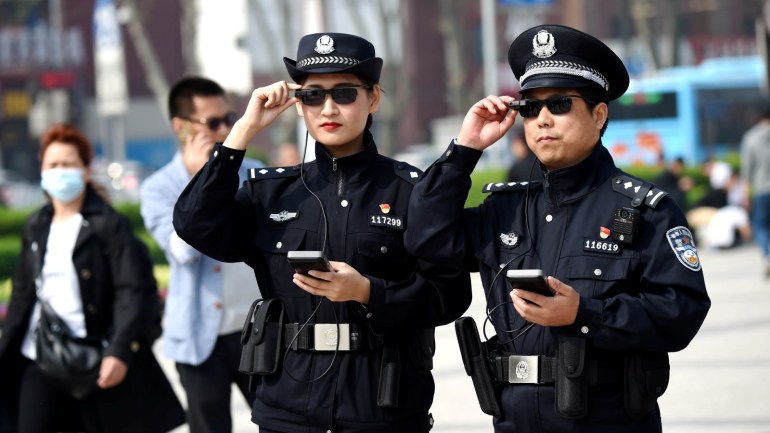 Police officers display their AI-powered smart glasses in Luoyang, Henan province, China April 3, 2018. Picture taken April 3, 2018. REUTERS/Stringer ATTENTION EDITORS - THIS IMAGE WAS PROVIDED BY A THIRD PARTY. CHINA OUT.