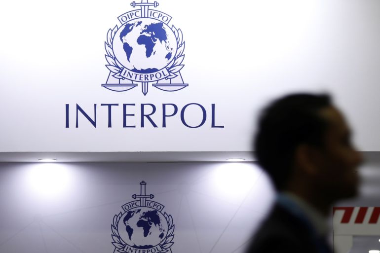 A man passes Interpol signages at Interpol World in Singapore July 2, 2019. REUTERS/Edgar Su